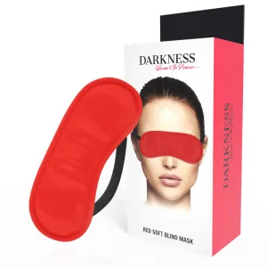 Rote Augenmaske neben Verpackung mit Bild einer Person, die die Maske trägt. Text: 