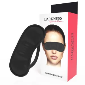 Schwarze Augenmaske neben Verpackung mit Bild einer Person, die die Maske trägt. Text: 