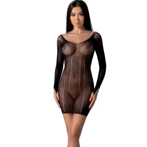 Woman in a black, openwork dress with long sleeves, standing against a white background.