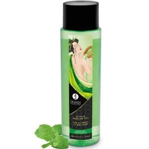 Grüne Flasche mit Shunga Duschgel, verziert mit asiatischer Kunst, daneben frische Minzblätter.