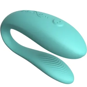 Turquoise, curved silicone sex toy with a textured end and button on top.