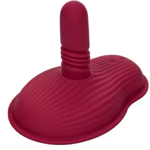 Red, textured silicone object with a rounded tip and wavy base.