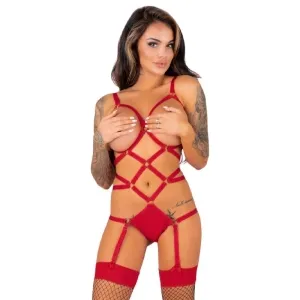 Woman in red lingerie with garter belt and fishnet stockings, tattooed arms, holds her hands in front of her chest.