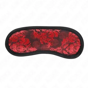 Rote Augenmaske mit schwarzem Rand und floralem Muster auf weißem Hintergrund.