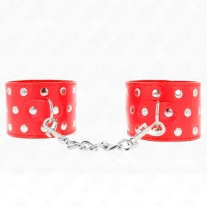 Red leather handcuffs with silver studs and chain, on a white background.