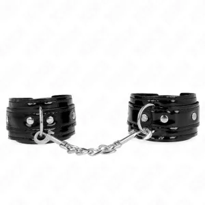 Black leather handcuffs with chain and metal rivets, on a white background.