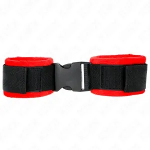 Black handcuffs with red plush lining and plastic buckle on a white background.
