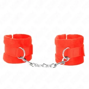 Red plush handcuffs with metal chain and carabiner hook on a white background.