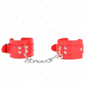 Red leather handcuffs with chain and buckles on a white background.