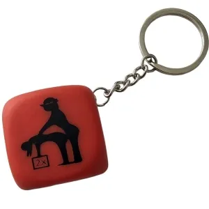 Red keychain with a black silhouette of two people in a humorous pose.