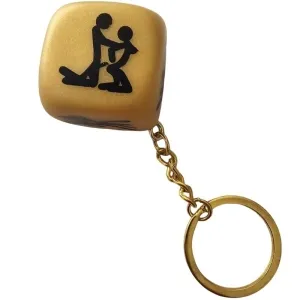 Golden cube keychain with a black silhouette of two figures in an intimate position.