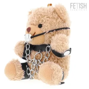 Plush bear with chains and gag, BDSM theme, on a white background.