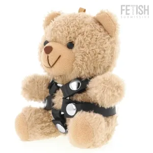 Plush bear with black leather harness and silver studs, sitting upright against a white background.