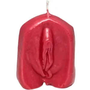 Red candle in the shape of a stylized female body with the wick at the top.