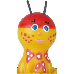 Bunte Kerze in Form eines Marienkäfers mit roten Punkten und blauen Augen, lächelndes Gesicht.