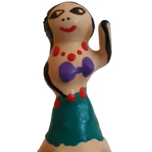 A small, colorful figure with a face, red jewelry, a purple top and a green skirt, raises one hand.