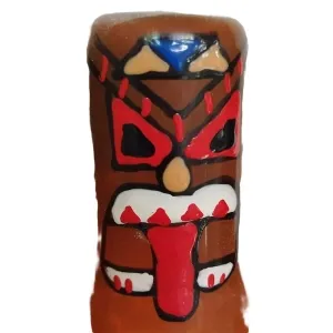 A brightly painted tiki face with red, black and white patterns on a brown background.