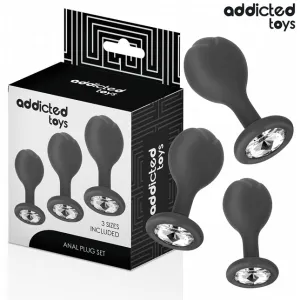 Schwarzes Anal-Plug-Set mit drei Größen, verziert mit Kristallen, neben der Verpackung von 