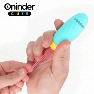 A person is holding a small, blue device with a yellow end and a pink strap.