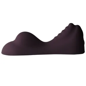 Dunkelviolettes, wellenförmiges Kissen mit unregelmäßiger Oberfläche, seitlich fotografiert.