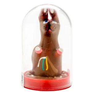 Chocolate bunny with colorful decorations in a transparent plastic casing on a red base.