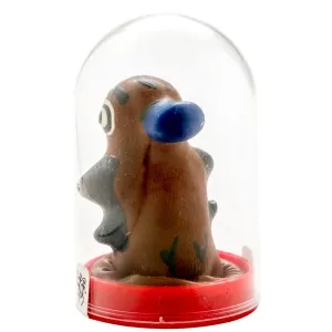 Brown toy figure with blue details in a transparent dome on a red base.