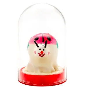 White figure with ladybug pattern under a glass dome on a red base.