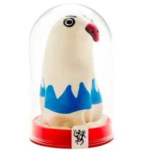 White figure with blue waves and red beak under a glass dome on a red base.
