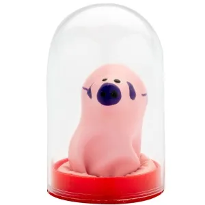 Pink piglet figurine with a purple nose in a transparent dome on a red base.