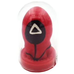 Red game piece with a black circle and white triangle, in a transparent plastic case.
