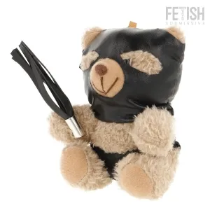 Teddy bear in black mask and leather outfit, holding a small whip.